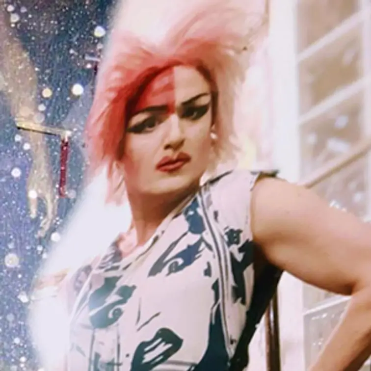 Anita posing with a white paint splattered background